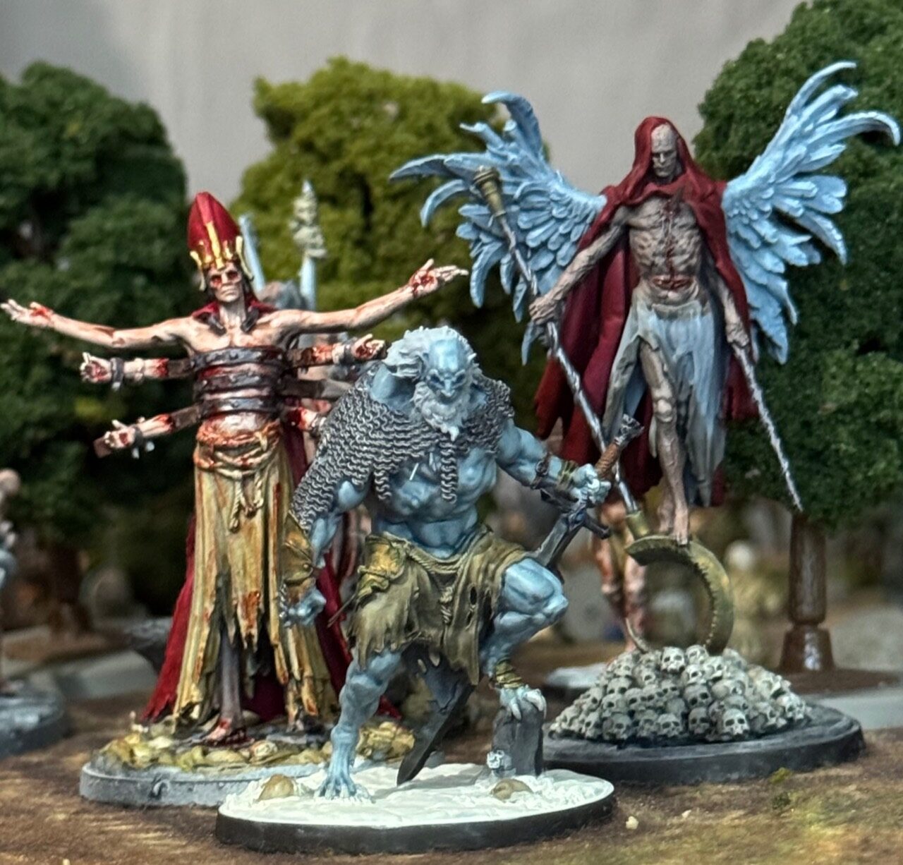 Black Oaths miniatures with winged and many-armed figures