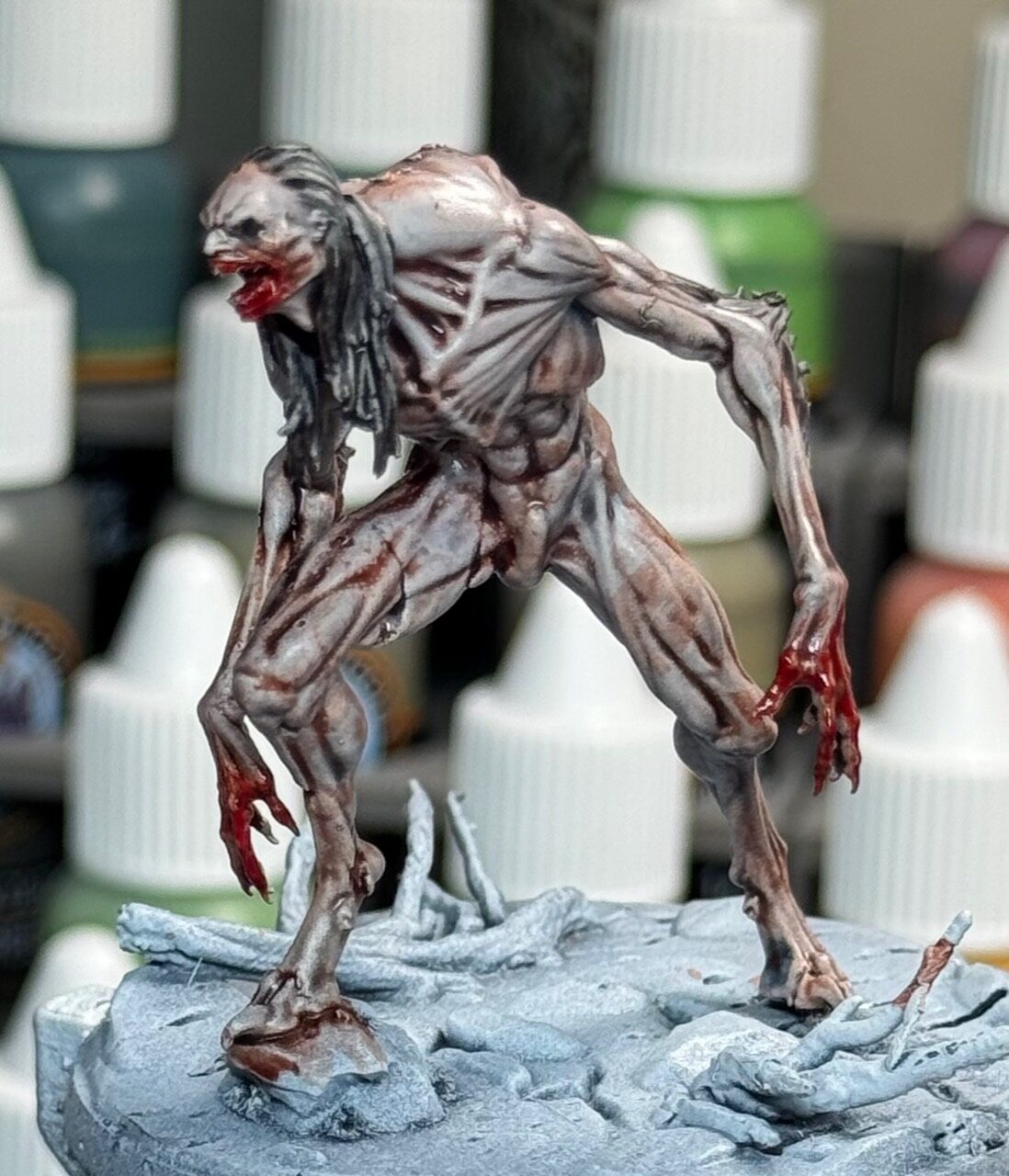 Pale ghoul miniature with bloodied hands