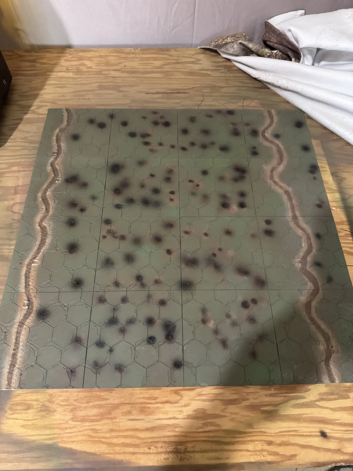 Finished green Death Spiral Battlefield assembled from printed sections with cratered hex spaces and boundary trenches