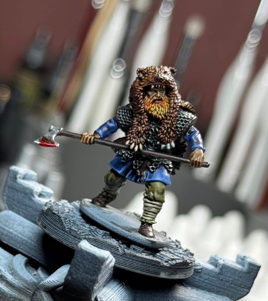 EINVIGI fighter in fur hood holding a bloodied axe