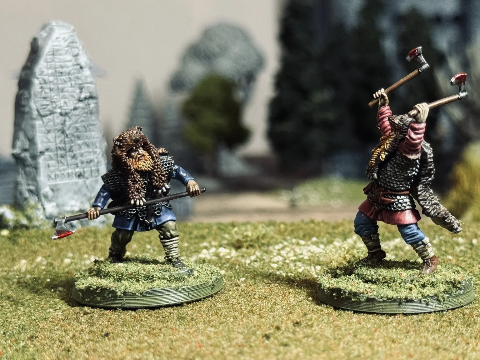 EINVIGI duel between two warriors near a carved runestone